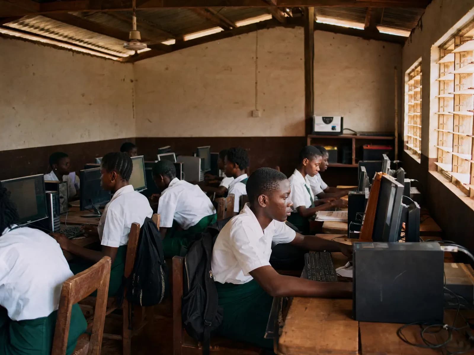 Students working in a school computer lab powered by a corner inverter cabinet
