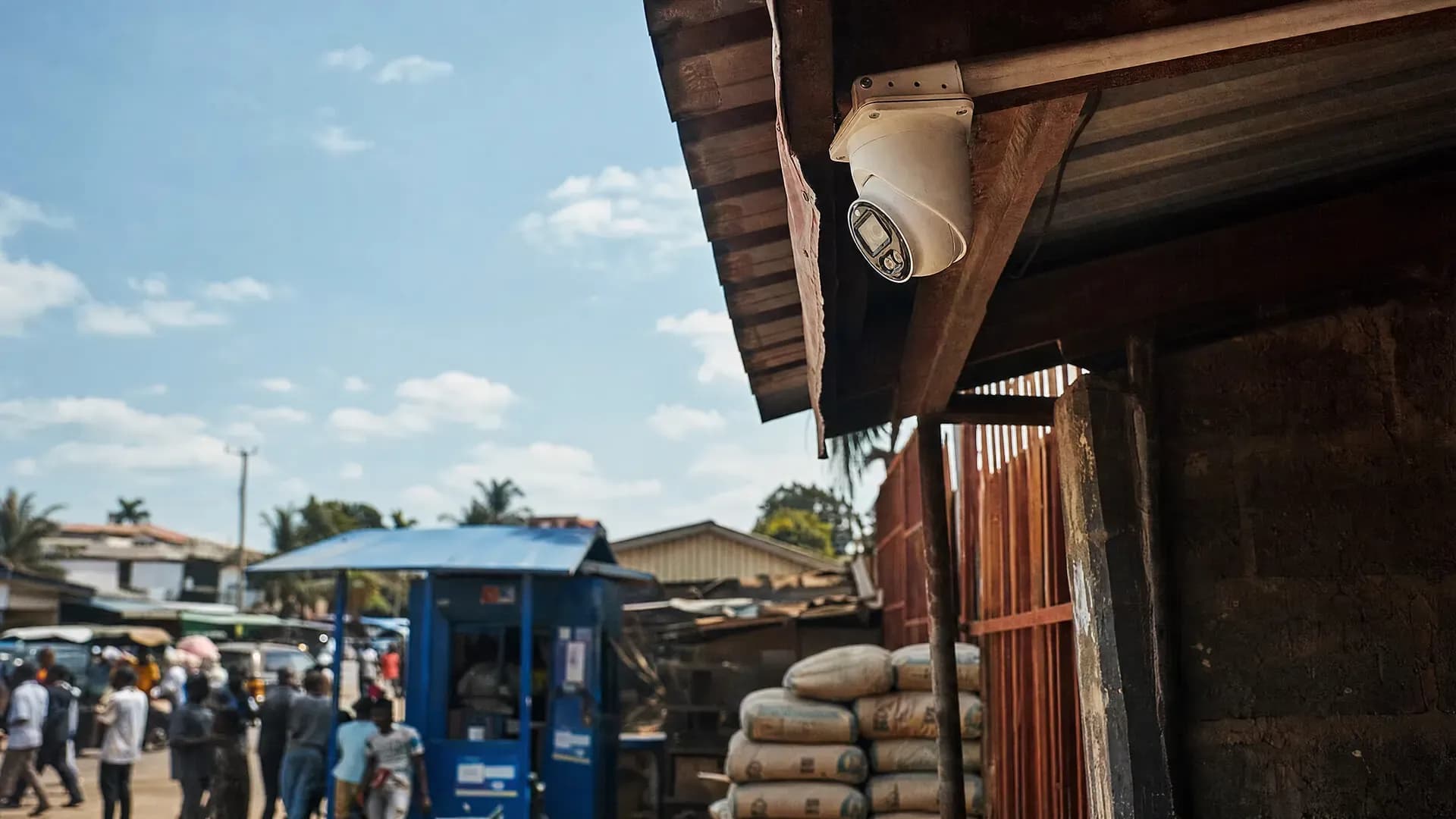 A PTZ dome security camera mounted above a busy Nigerian street